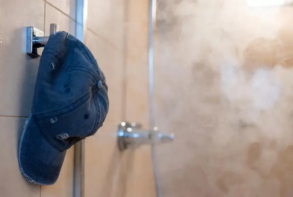 Fixing baseball cap with bathroom steam