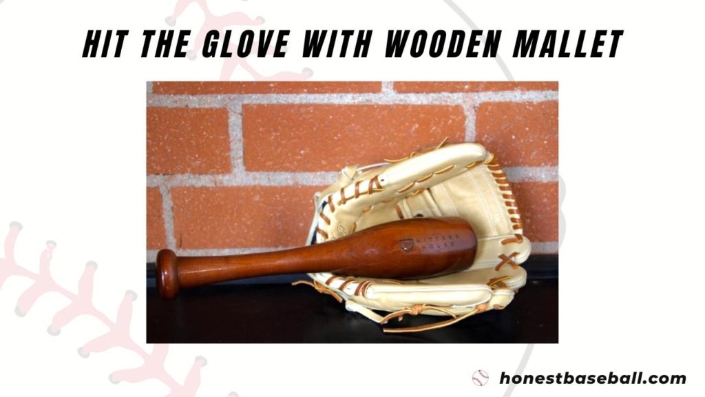 Hitting a baseball glove with a wooden mallet