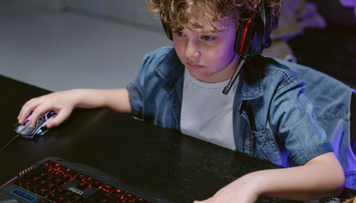  a boy playing computer game 