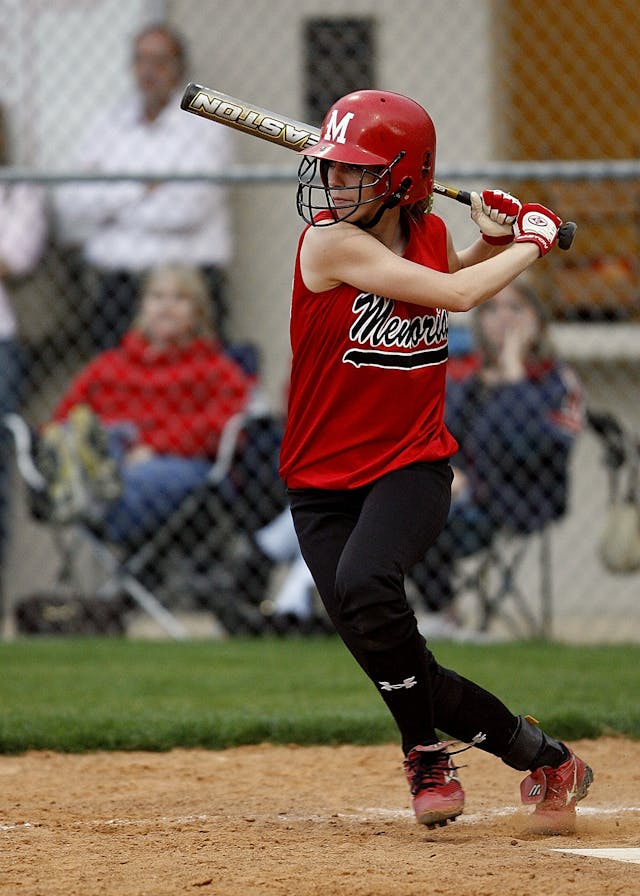 a softball player is trying to hit with high performance bat 