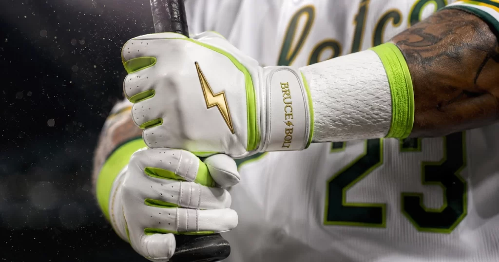 Baseball player wearing white and neon green Bruce Bolt Cabretta leather batting gloves